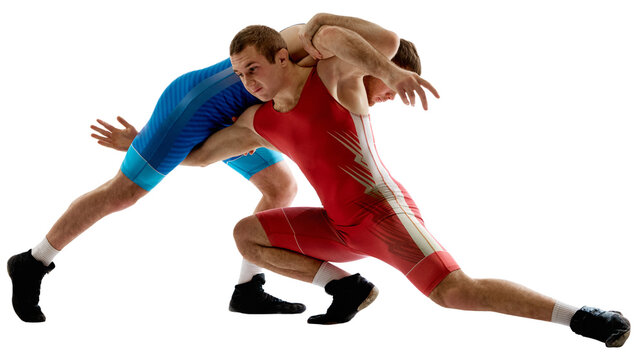 Two strong and skilled wrestlers in blue and red wrestling uniform are wrestling and doing grapple against transparent background. Concept of fair wrestling, championship, win competition.