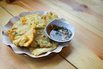 Traditional Indonesian tempe mendoan served hot with dipping sauce. Food concept
