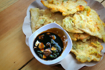 Traditional Indonesian tempe mendoan served hot with dipping sauce. Food concept

