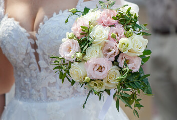 A bouquet of flowers in the hands of the bride