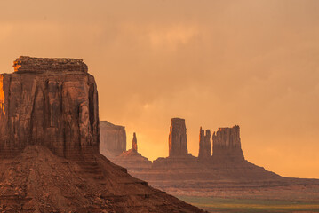 Sunset at Monument Valley with towering buttes and desert landscape.