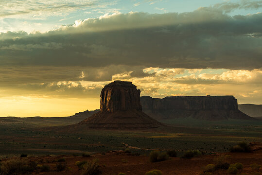 Monument Valley butte in dramatic evening light with storm clouds