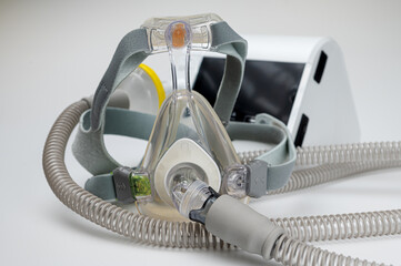 Continuous positive airway pressure system includes of CPAP machine, mask, tube on white background.