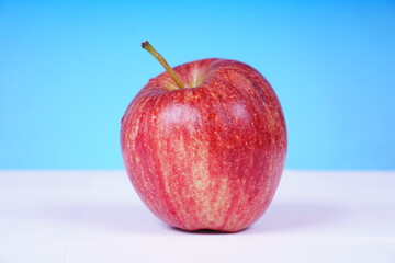 Bright red apple with a glossy surface. Food concept