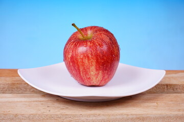 Bright red apple with a glossy surface. Food concept