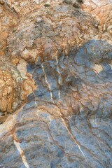 the texture of the old marbled coastal rock