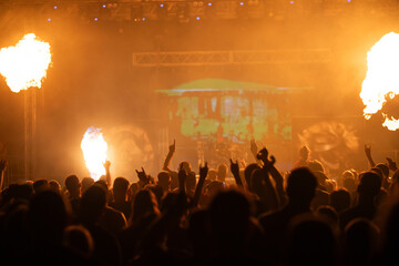 Crowd at concert and colorful stage lights.