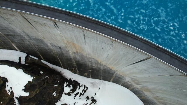 4k Drone Aerial Of Road On Top Of Dam With Vibrant Blue Glacial Water Of Lac de Moiry Dam On lake In Grimentz Switzerland