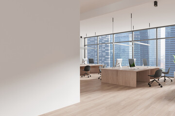 An open space office interior featuring large windows overlooking a cityscape, wooden desks, and chairs. Modern design concept for coworking spaces. 3D Rendering
