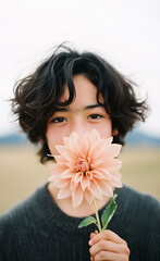 Japanese boy holding a dahlia to his mouth generated by AI