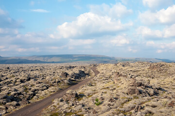 View of a dirt road among lava fields.