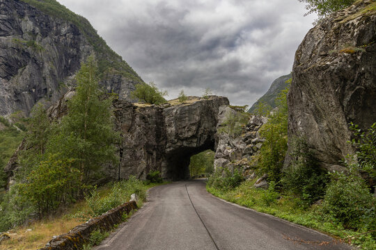 Tunnel on a disused stretch of road in the Norwegian mountain landscape. The road was closed due to a high risk of landslides and is located in extreme but beautiful surroundings