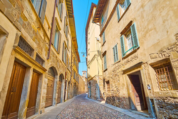 Walk down narrow Via Arena, Bergamo, Italy