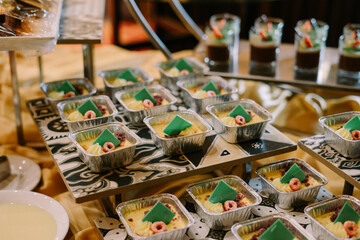 Assorted traditional steamed cakes (kue basah) neatly arranged in a white styrofoam container,