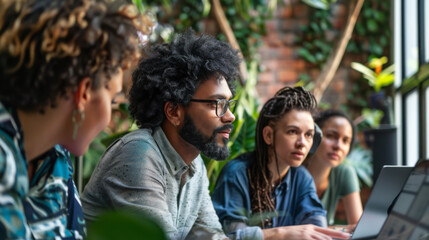 Group of diverse professionals collaborating in a cozy workspace surrounded by plants during a brainstorming session