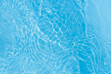 Blue water with ripples on the surface. Defocus blurred transparent blue colored clear calm water...