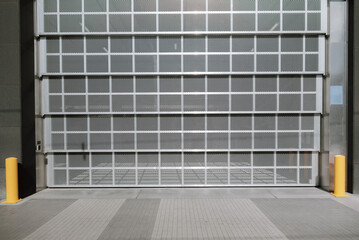 Steel wire mesh Gate Door for Security System of Warehouse Storage. Automatic Factory Door Indoor. © Somkiat