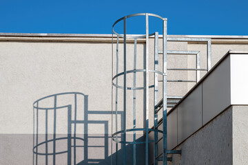 Fixed steel caged ladder on industrial building