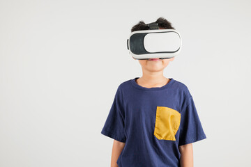 Smiling young kid boy confidence excited wear VR headset device during virtual reality experience isolated white background, Asian happy portrait primary child playing video game studio shot