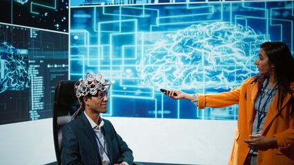 Presenter talking at AI neuroscience forum bringing together IT professionals, showing EEH headset demonstration of latest developments in artificial intelligence mind transfer, camera B