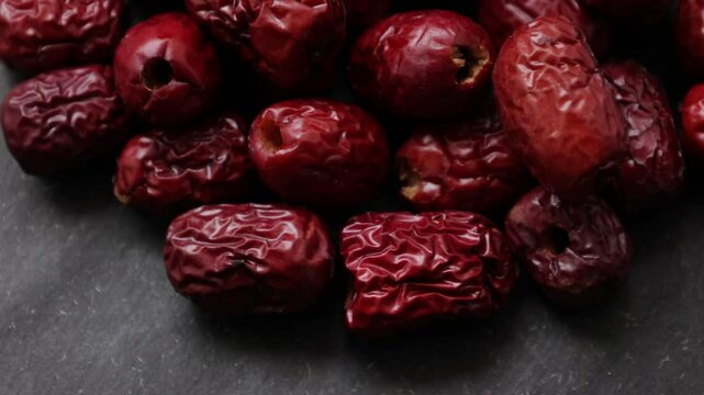 dried jujubes fruit on a black background