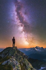Man on Mountain Top Looking at Night Sky