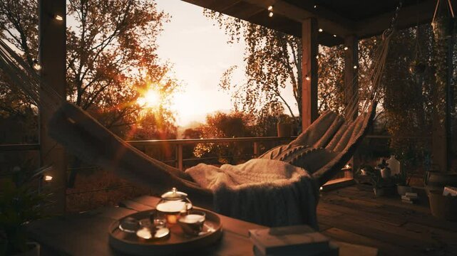 Golden autumn in a country house. Beautiful terrace in a private house. Golden autumn in a country house. Autumn sunset on the terrace. Hammock on the terrace