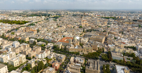 Fototapeta premium Panoramic aerial view of the southern part of the historic center of Lecce, Puglia, Italy. In the foreground are the Church of Carmine and the Basilica of San Giovanni Battista al Rosario.