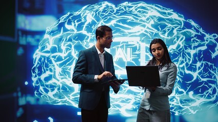 Coworkers using AI neural networks modeled after human brain, brainstorming ways to solve complex...