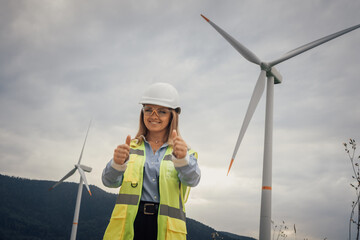 A dedicated Female Engineer at the Wind Farm celebrates advancements in Sustainable Energy,...