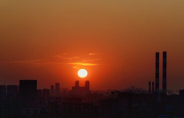 Downtown Sunset Silhouette Panoramic lifetime shot cityscape orange, red, yellow color display in the sky city lots of production and cranes and construction