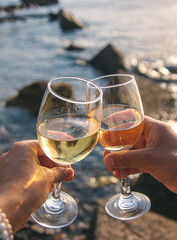 Glasses of wine on the seashore. Selective focus.