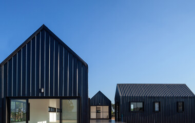 Architecture details of modern black metal sheet facade storage house with gable roof minimal style