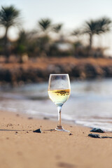 Glasses of wine on the seashore. Selective focus.
