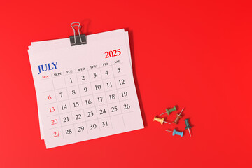 July 2025 Calendar and Thumbtacks on Red Background. 3d Rendering