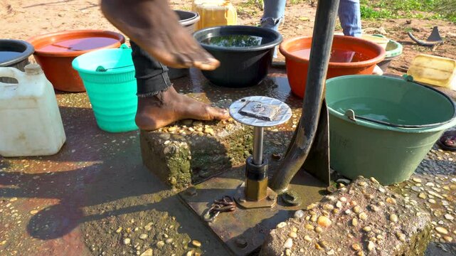 water pump with buckets and feet Africa 4K