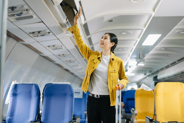 ttractive Asian female passenger of airplane sitting in comfortable seat while working laptop and tablet in style, work with grace..