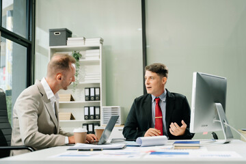 Happy businesspeople while collaborating on a new project in an office