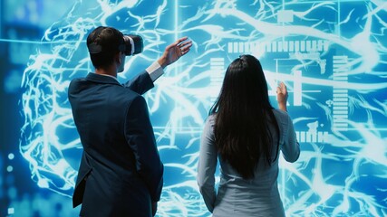 Engineer wearing VR headset looking at hologram of artificial intelligence human brain simulation,...