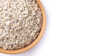 Rolled oats, healthy breakfast cereal oat flakes in bowl isolated on white background. Top view. Copy space