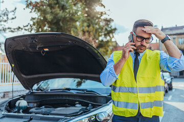 Stressed Man Calling for Roadside Assistance with Broken Car