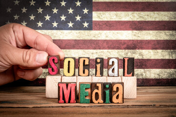 SOCIAL MEDIA. Colorful letters of the alphabet on a wooden texture table