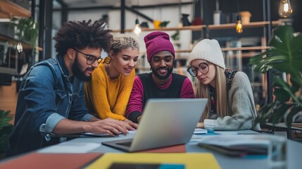 Diverse group of young people working on a laptop together