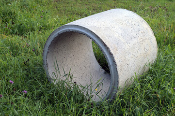 Concrete ring for a well on green grass.