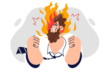 Angry business man is nervous and feeling aggressive, standing with fire over head