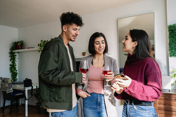 Friends Enjoying Wine and Sharing a Laugh Indoors..