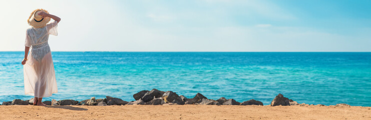 Woman in a hat on the seashore. Selective focus.