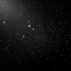 Fototapeta premium A black background with white specks of light, simulating a night sky full of stars.