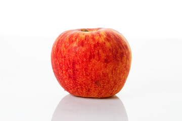 Closeup of ripe organic red apple on white table background. Selective focus.