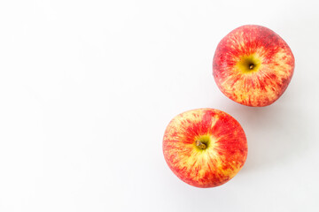Closeup of ripe organic red apple on white table background. Selective focus.